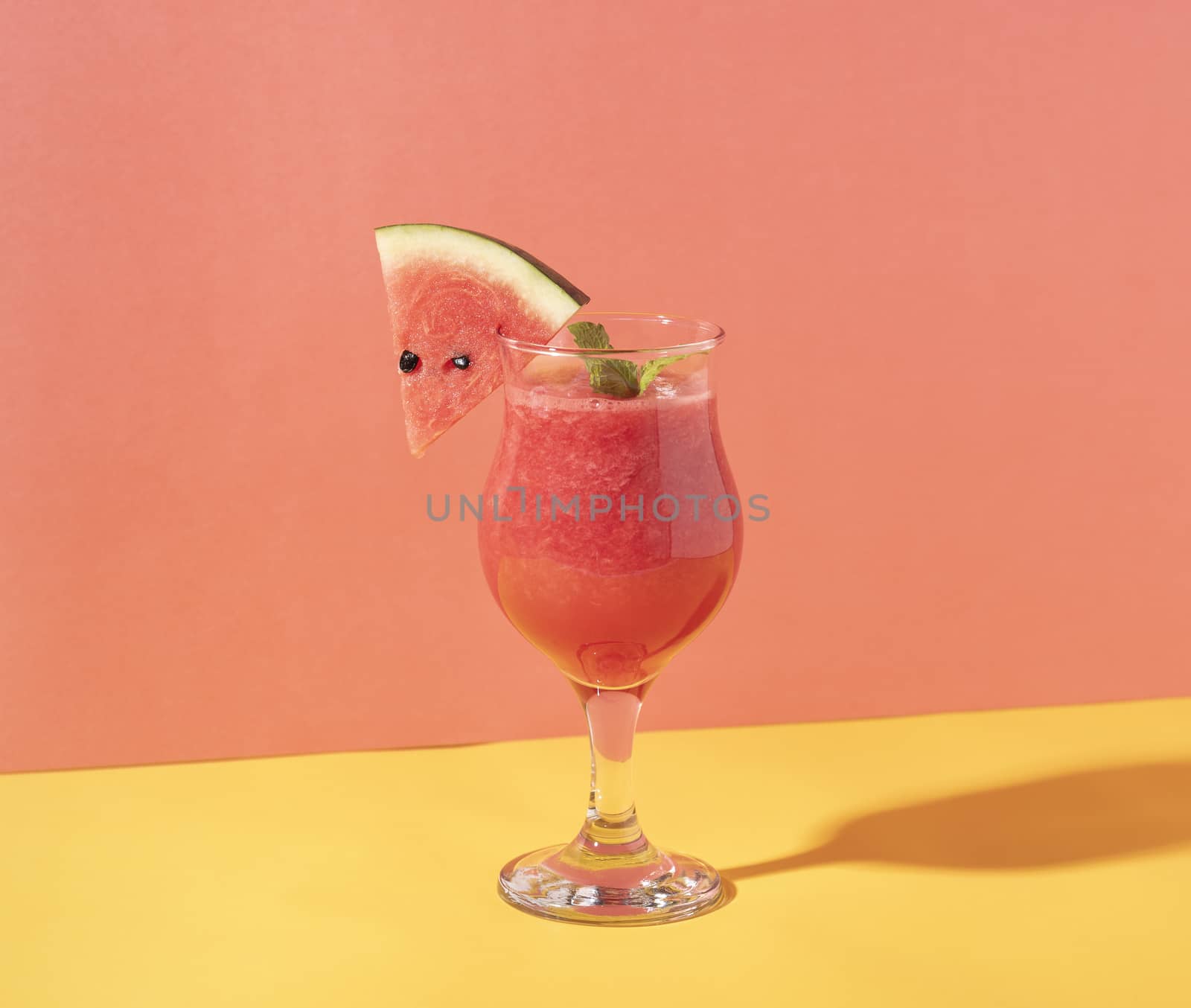 Fresh water melon juice and watermelon slice on color background. summer drink.