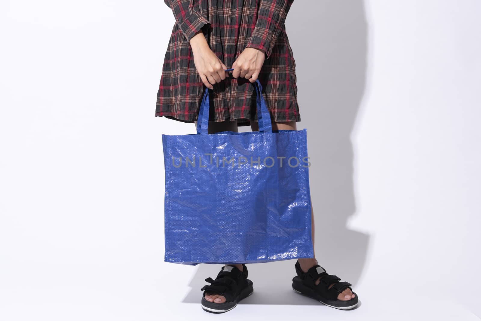 Girl is holding bag plastic for mockup blank template isolated on gray background. global warming concept.