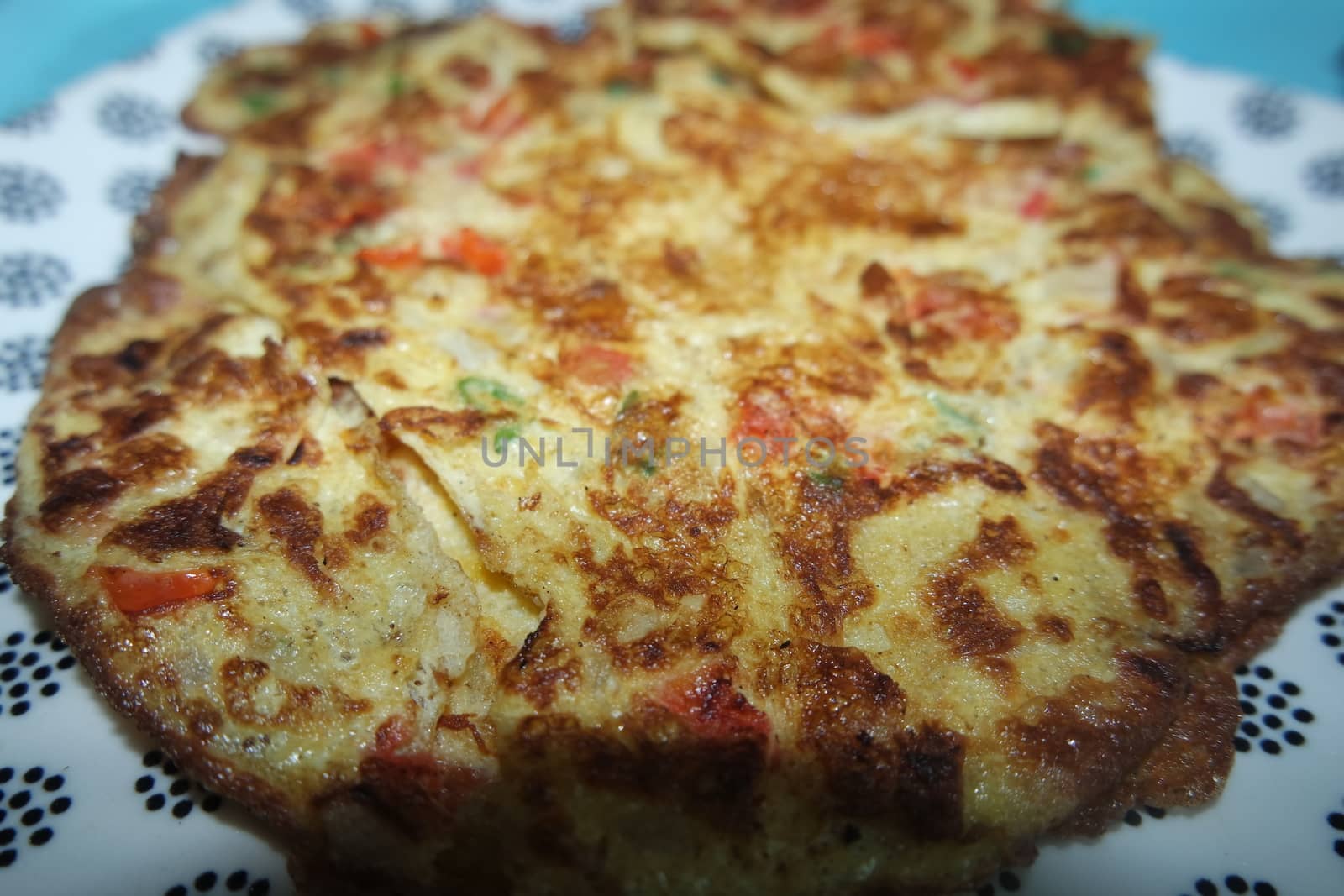 Close-up viewof egg omelet with peppers and spices sprinkled by Photochowk