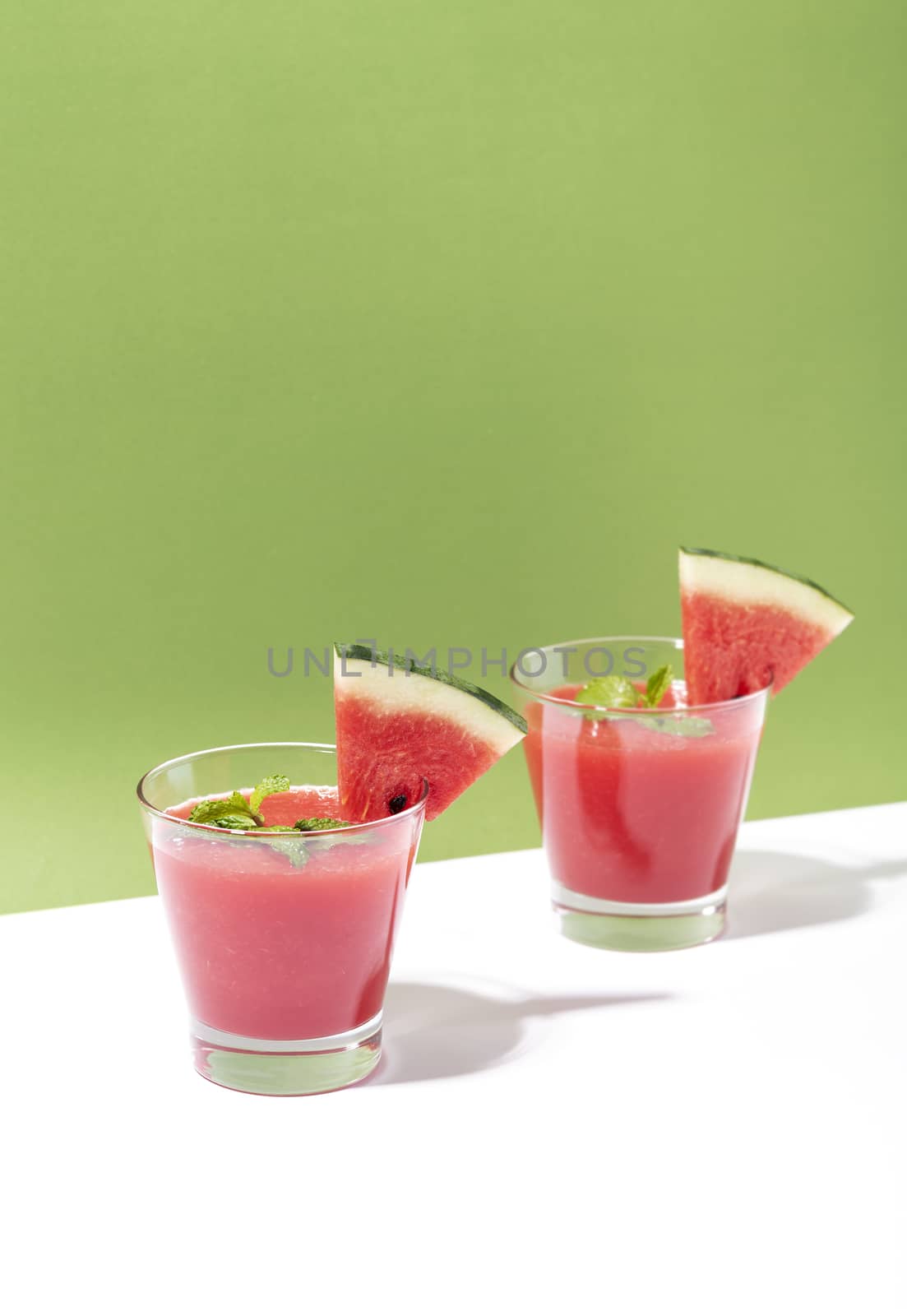 Fresh water melon juice and watermelon slice on color background. summer drink.