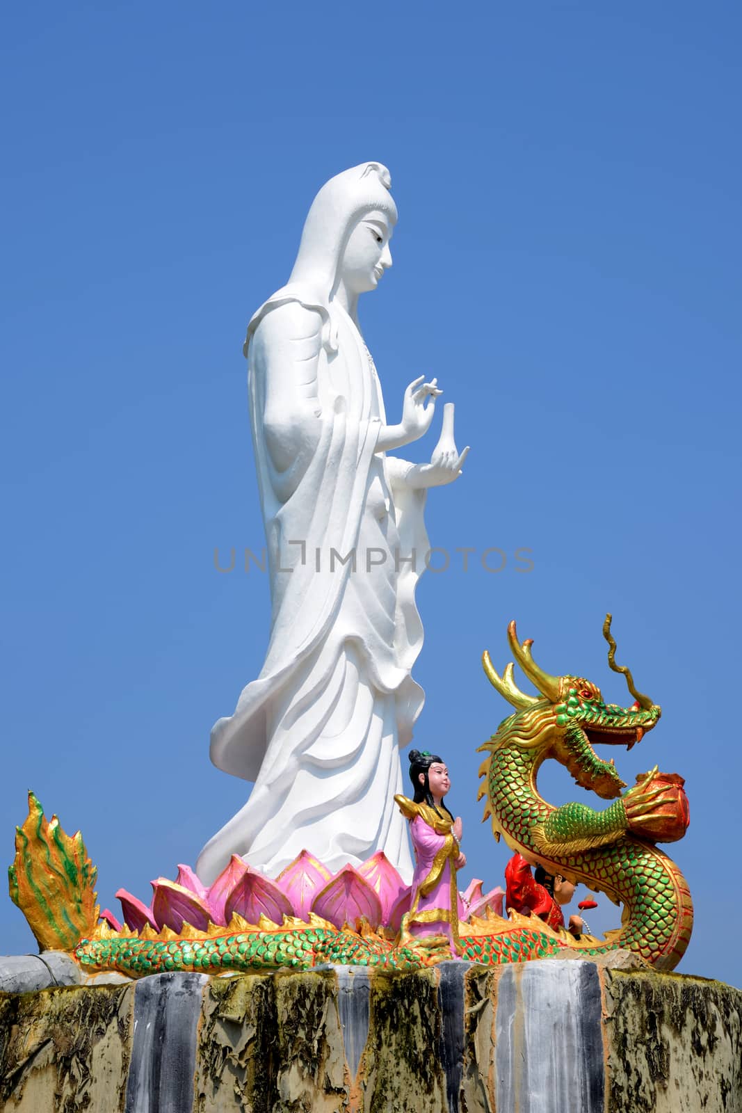 White guanyin stand on blue sky background.