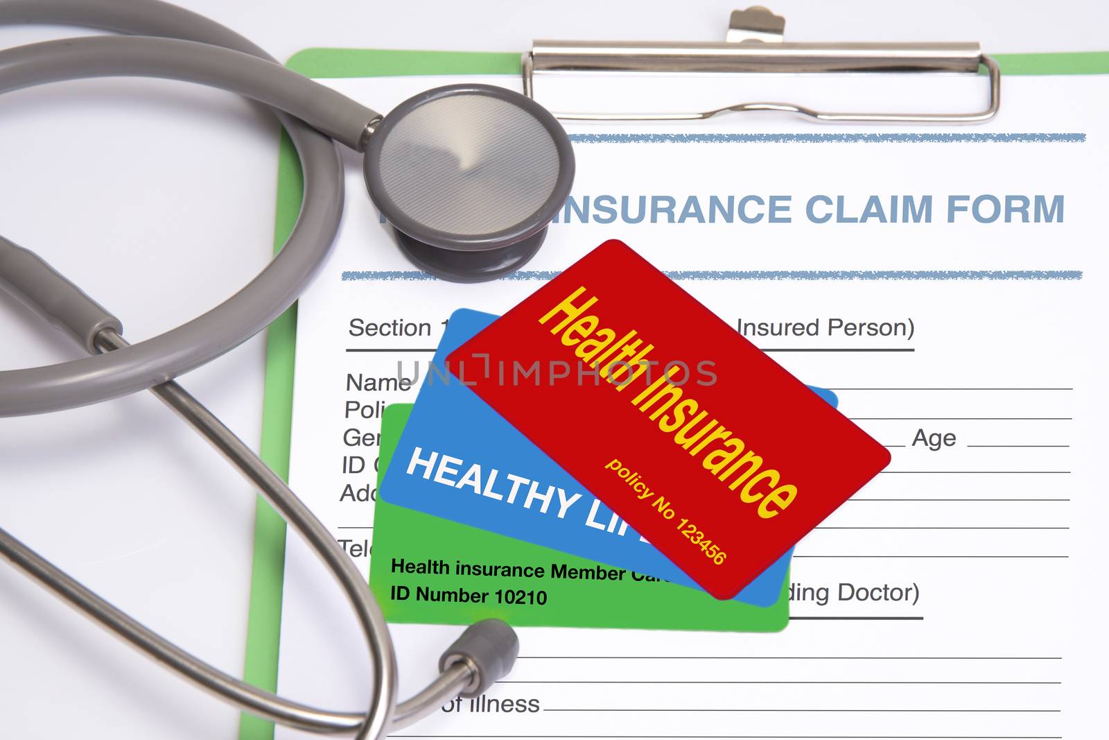 Various health insurance cards lay on insurance claim form.