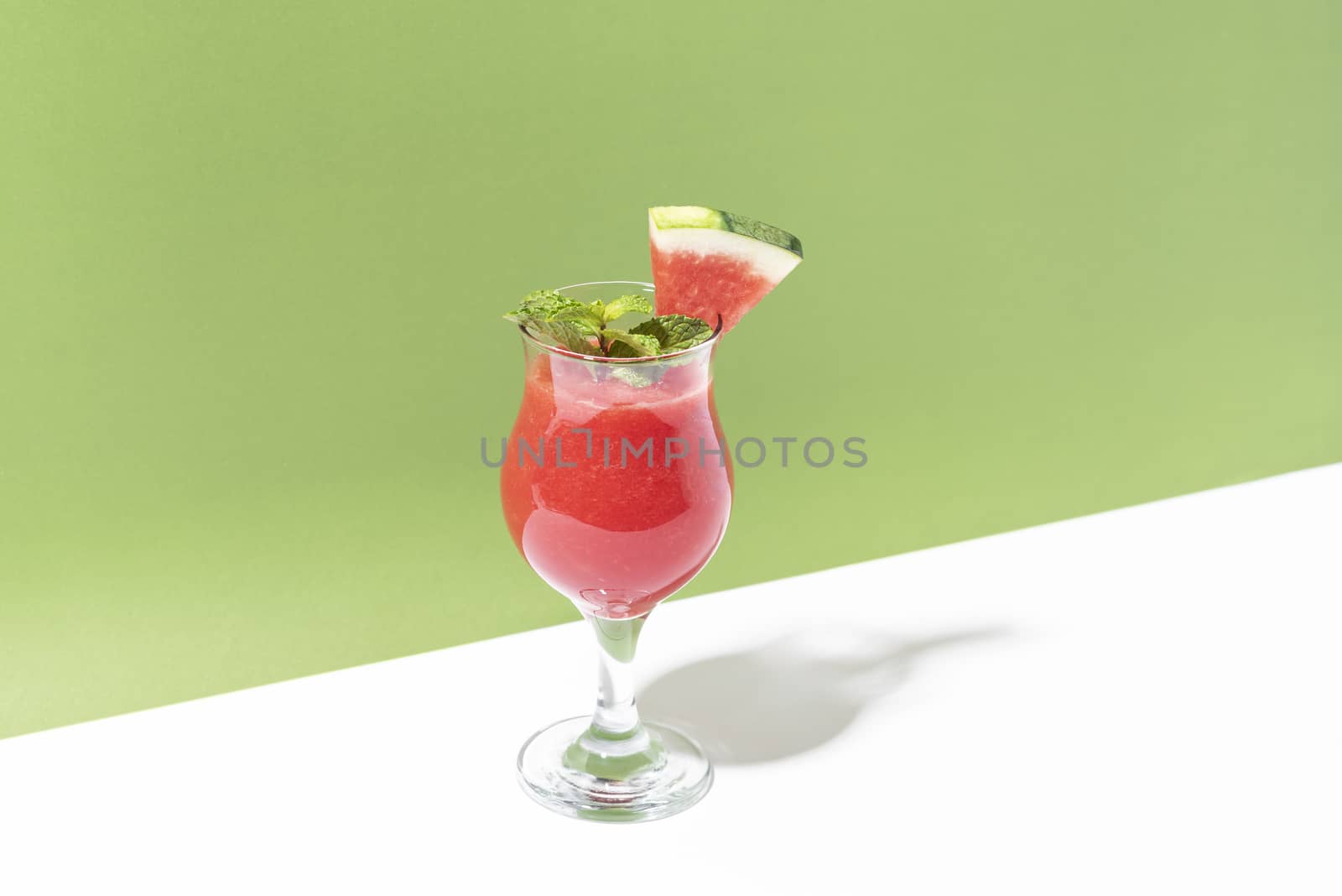 Fresh water melon juice and watermelon slice on color background. summer drink. by barameeyay