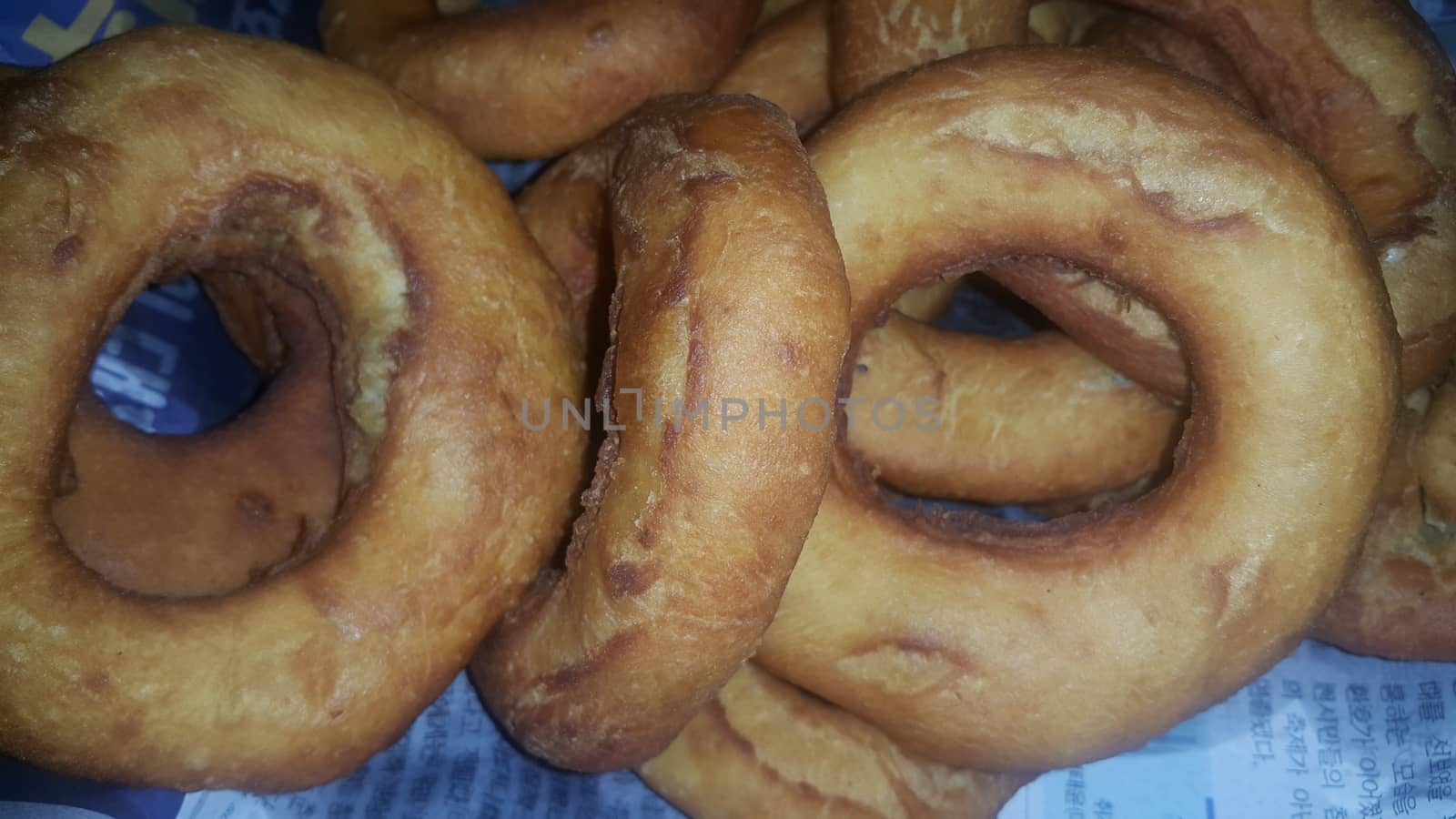 Closeup view of a set of freshly prepared donuts. Donuts are brown color and tasty food