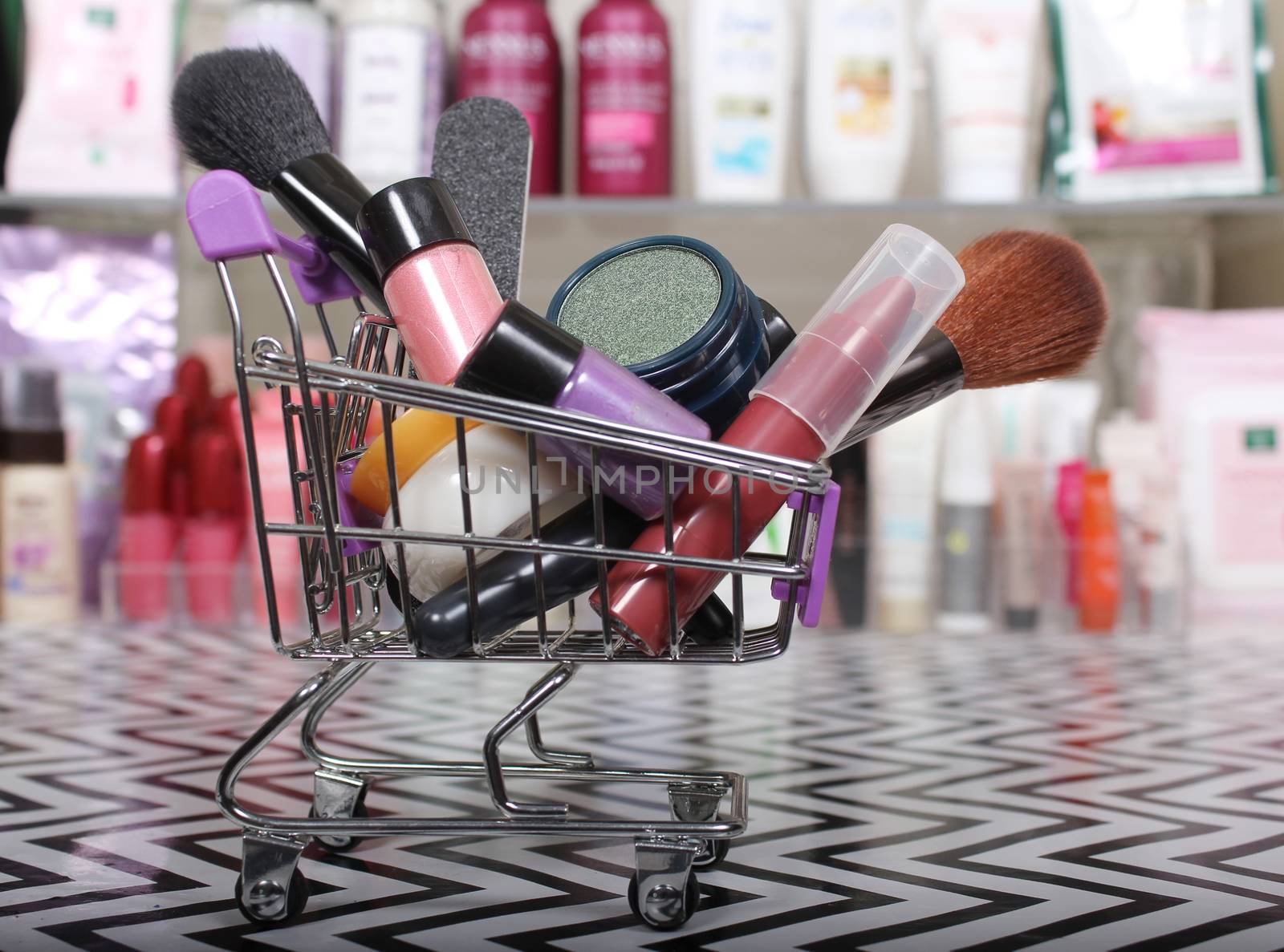 Various Beauty Products in shopping basket with blurred cosmetics by Marti157900
