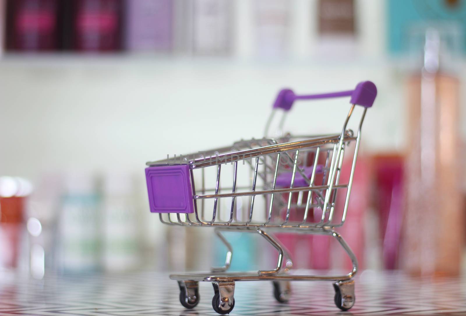 Empty shopping basket with blurred cosmetics by Marti157900