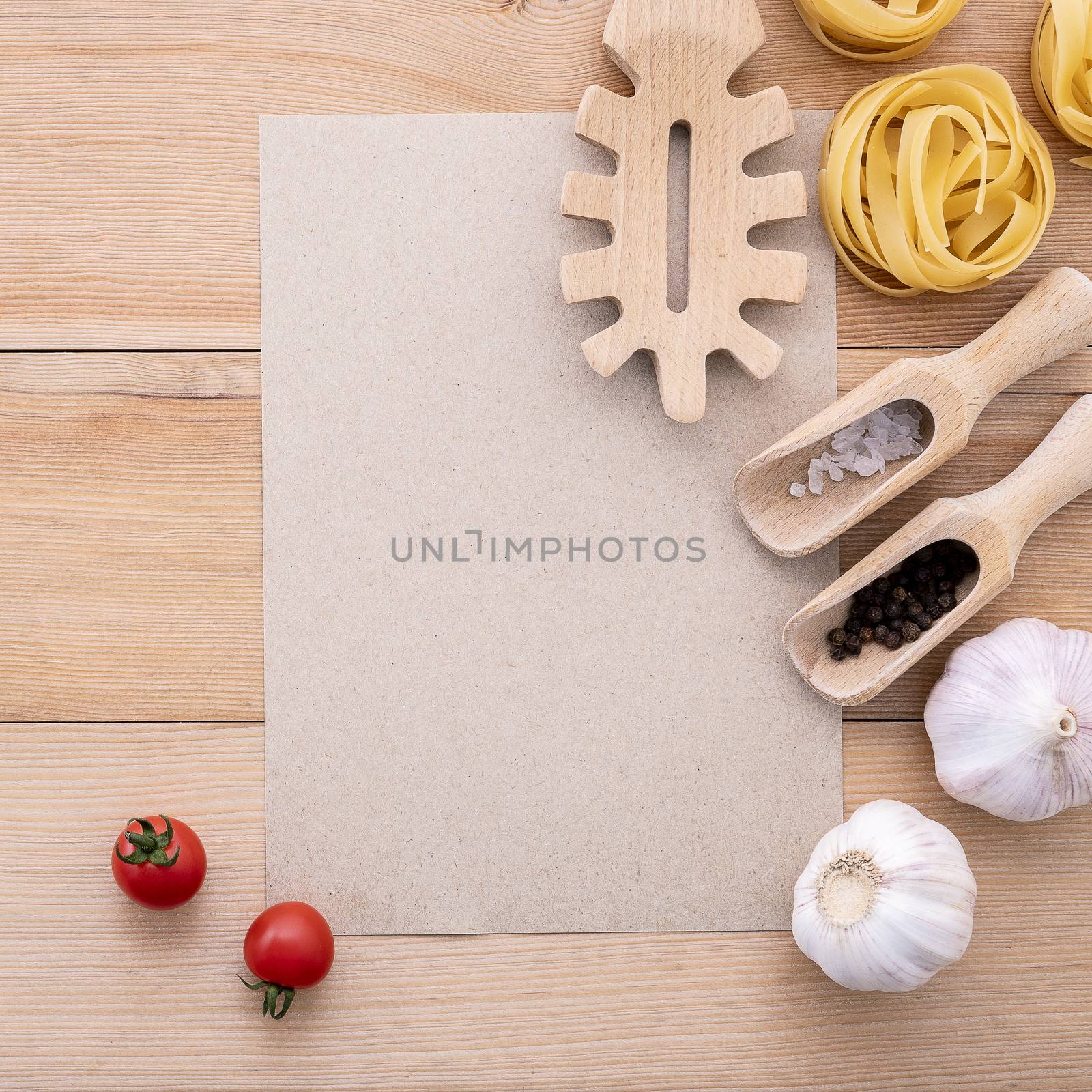 Italian foods concept and menu design . Blank paper and  pasta ladle on wooden background.