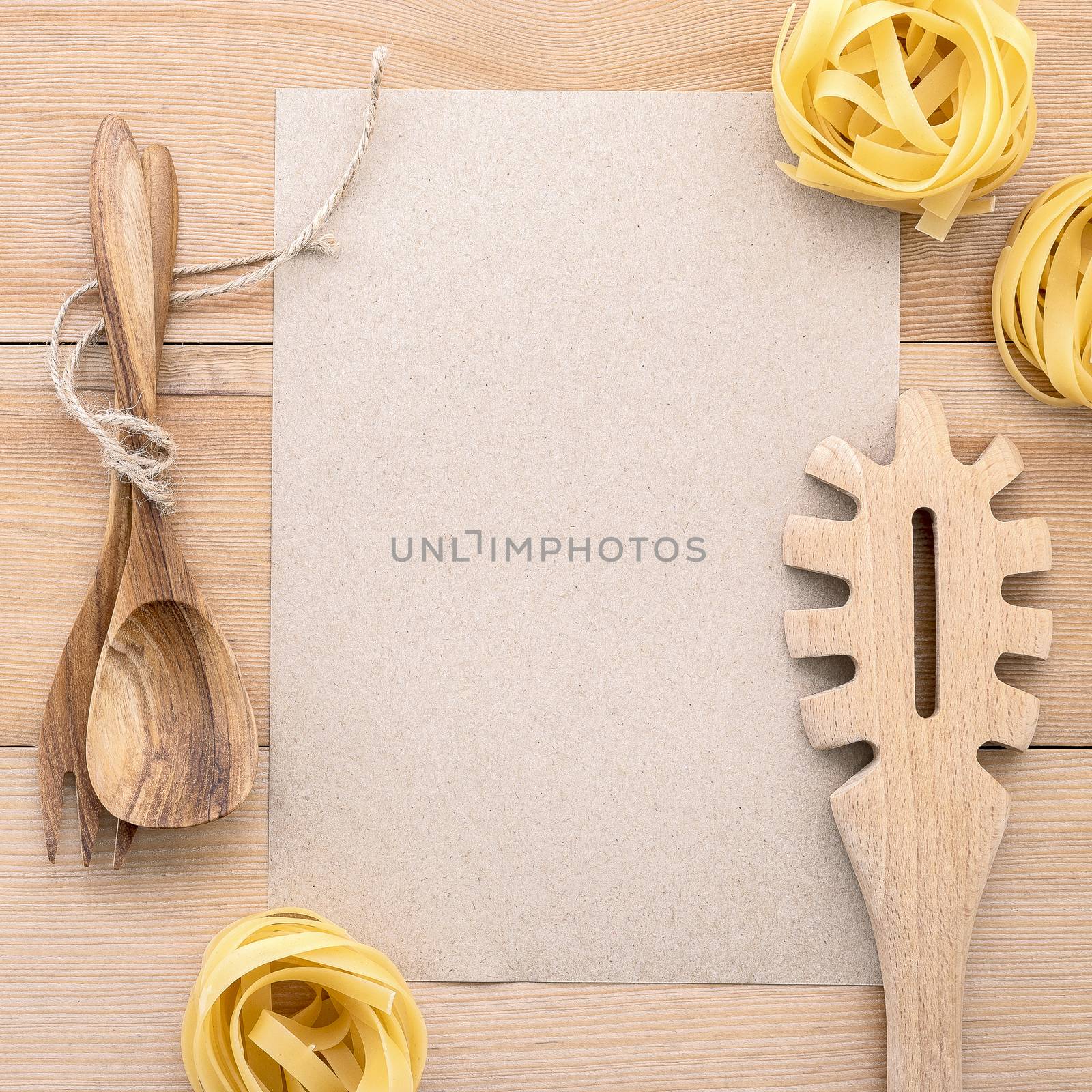 Italian foods concept and menu design . Blank paper and  pasta ladle on wooden background.