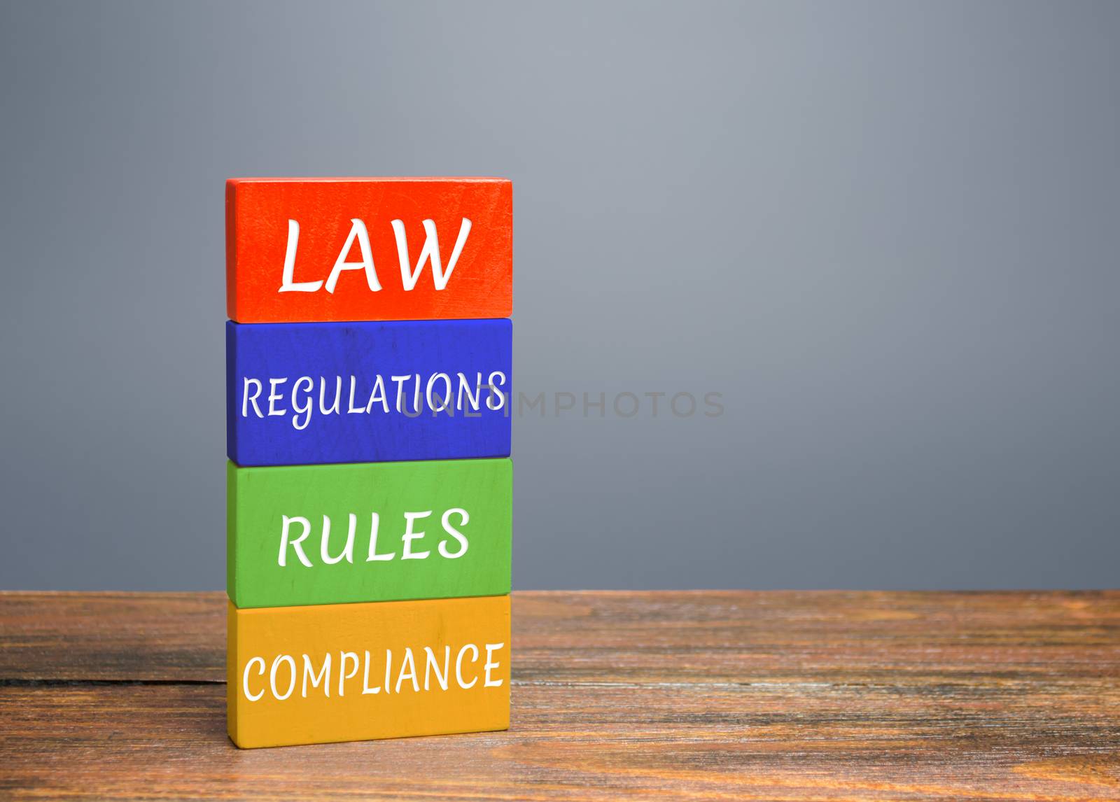 Colored blocks with words law, regulations, rules, compliance. Ease doing business. Quality criteria for goods, services. Protection national domestic producers manufacturers from strong competition