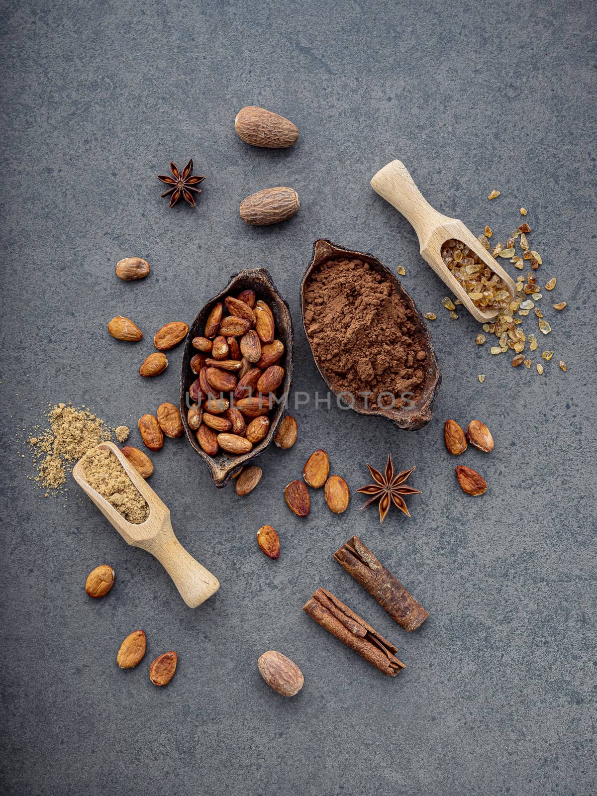 Cocoa powder and cacao beans on stone background. by kerdkanno