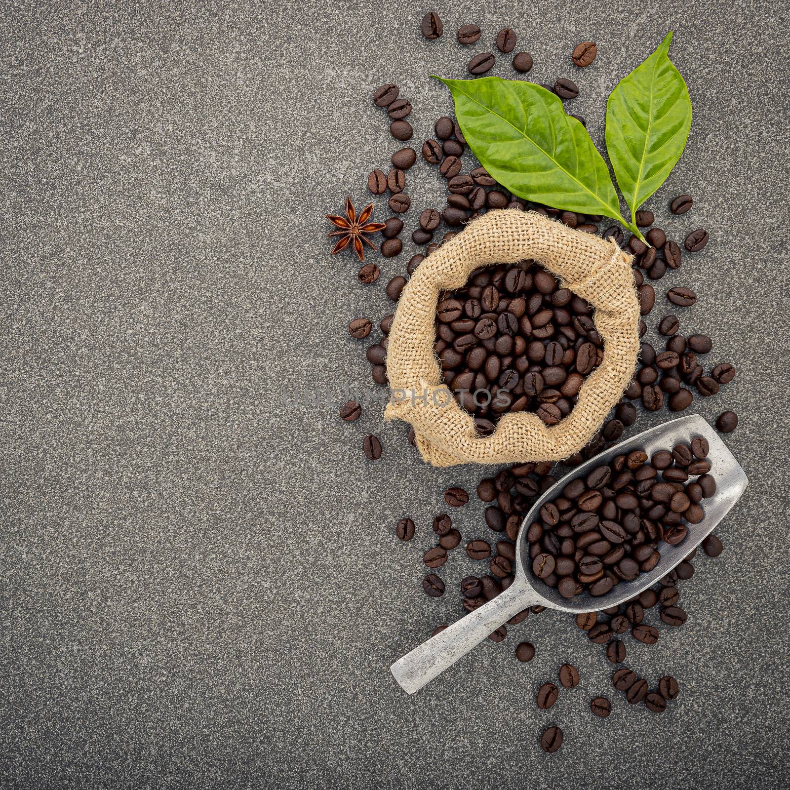 Dark roasted coffee beans on stone background. Top view with cop by kerdkanno