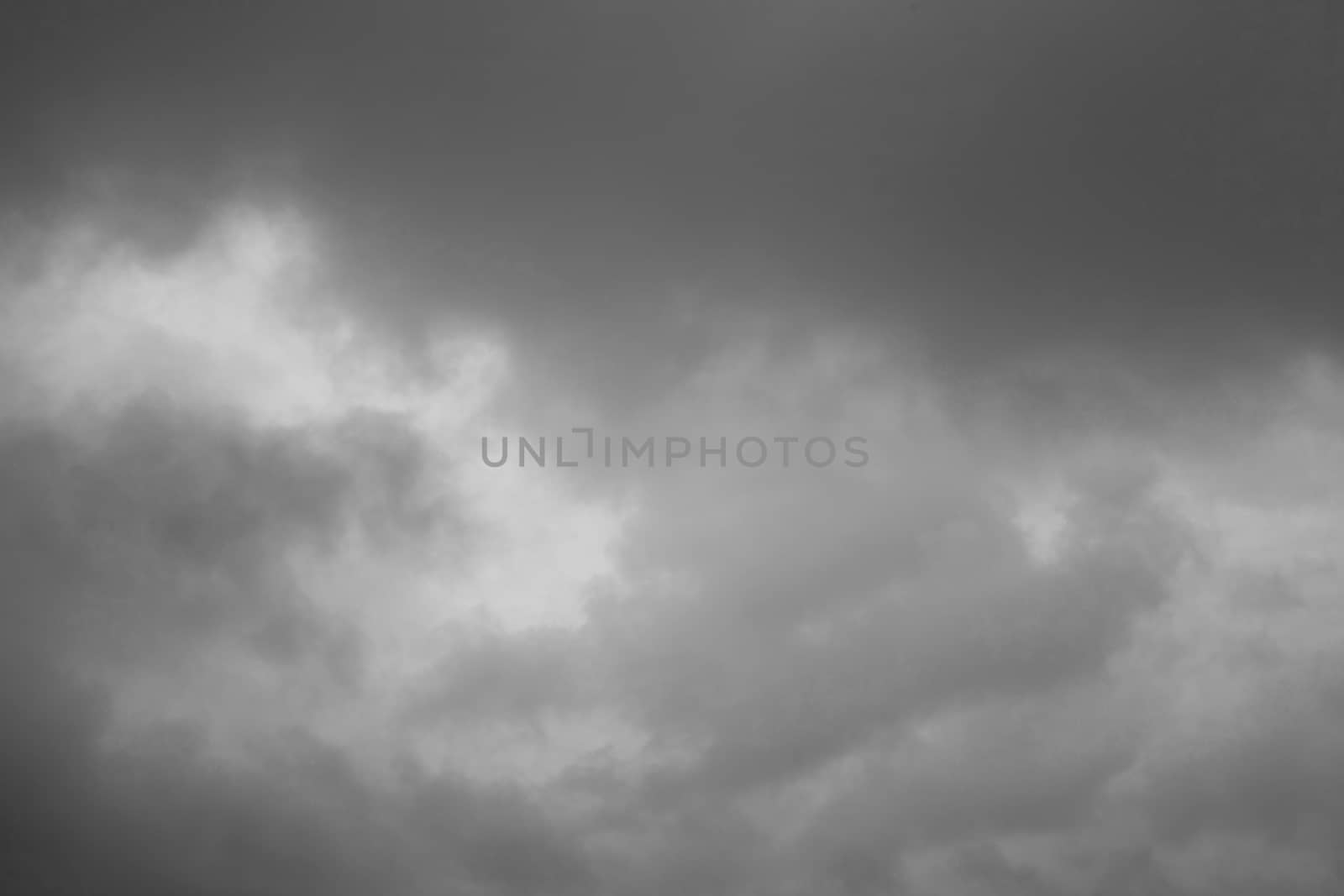 Cloudscape background of overcast cumulus clouds black & white monochrome image