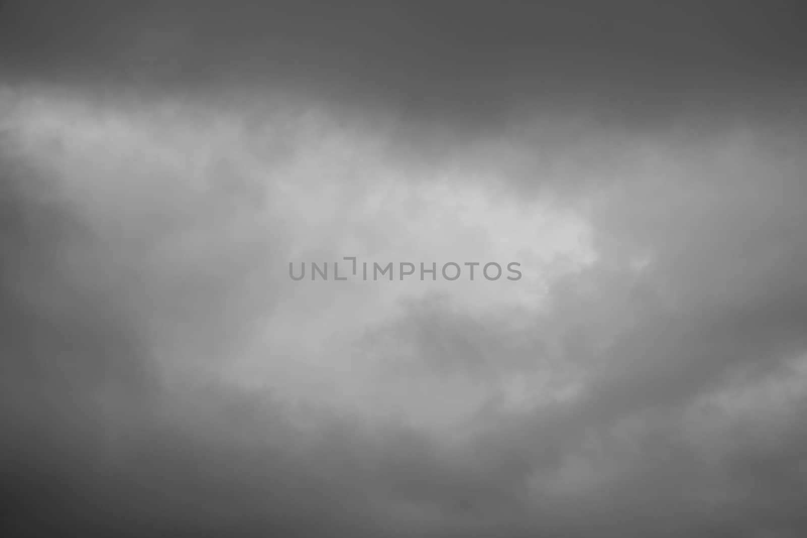 Cloudscape background of overcast cumulus clouds black & white monochrome image