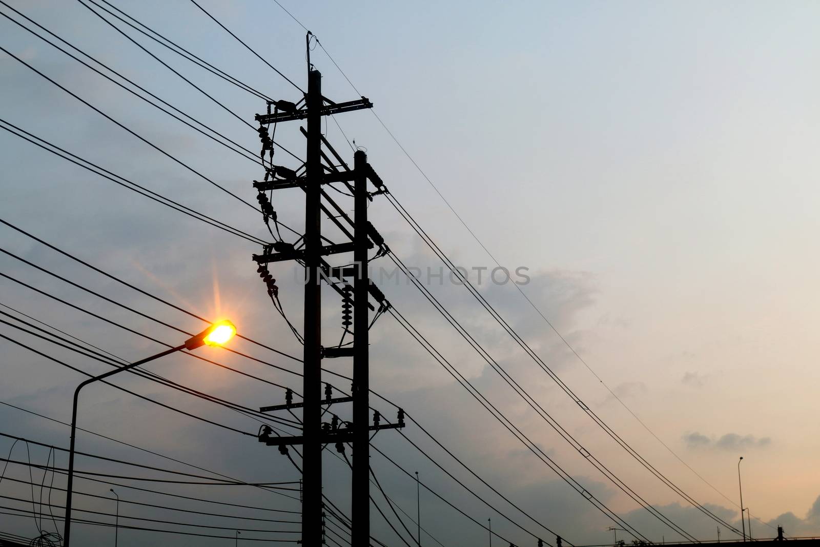 Electric pole power Tangle wire danger, wire electrical energy and light at street road on sky background evening