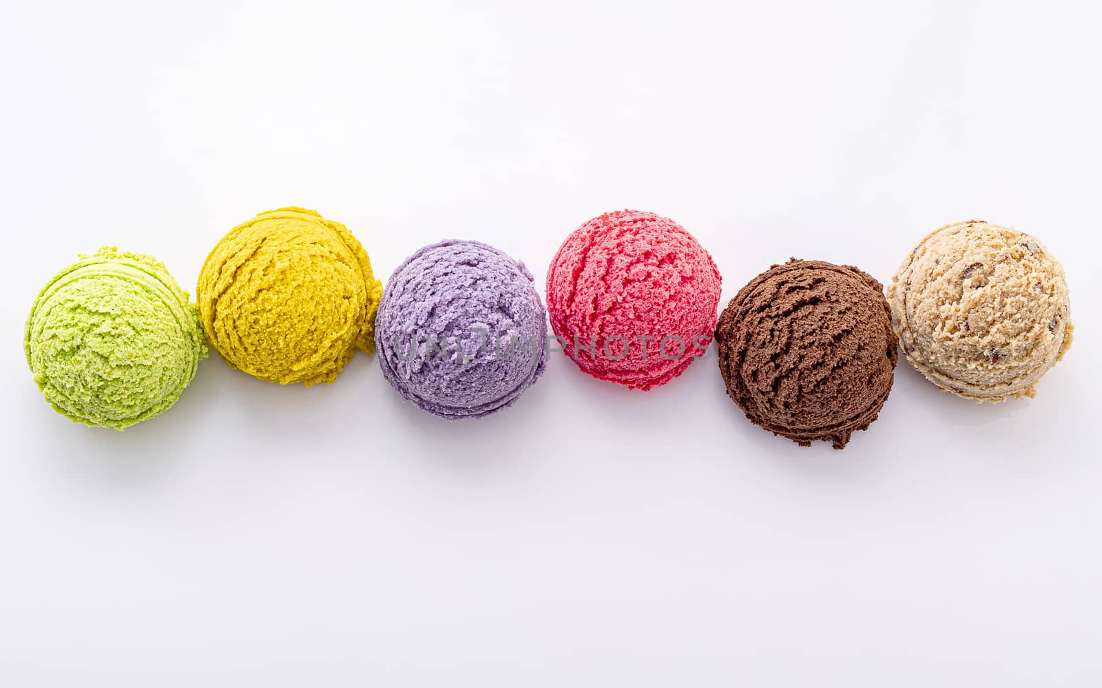 Various of ice cream flavor ball blueberry ,lime ,pistachio ,almond ,orange ,chocolate and vanilla isolate on white background . Summer and Sweet menu concept.