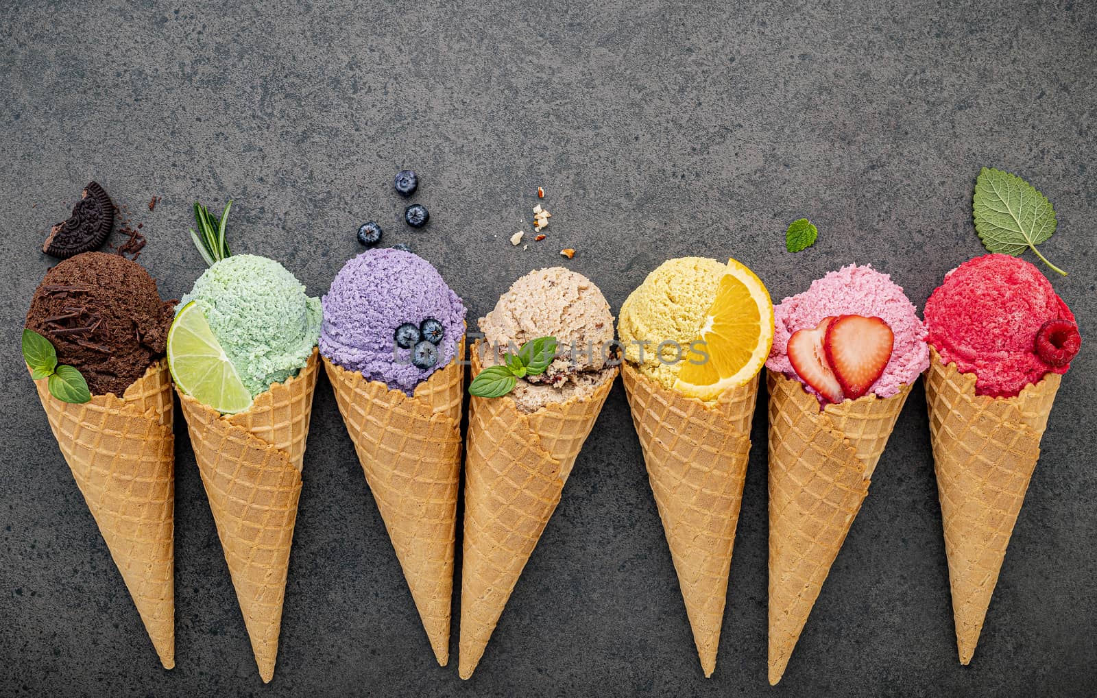 Flat lay ice cream cones collection on dark stone background . Blank crispy ice cream cone with copy space for sweets menu design.