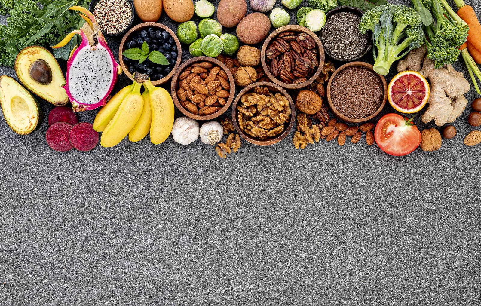 Ingredients for the healthy foods selection. The concept of healthy food set up on dark stone background.