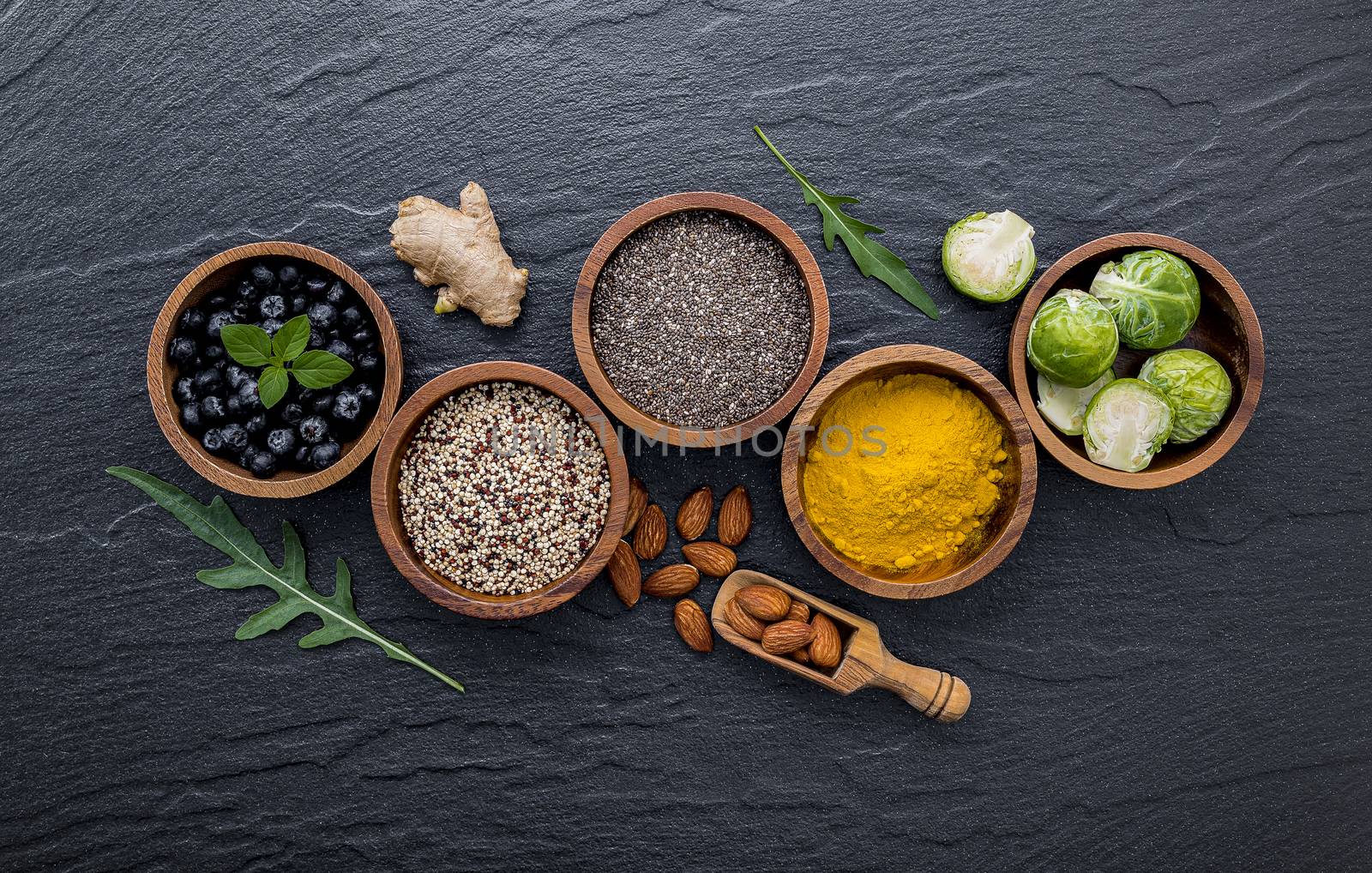 Super foods on in wooden bowl. Selection food and healthy food set up on dark stone background.