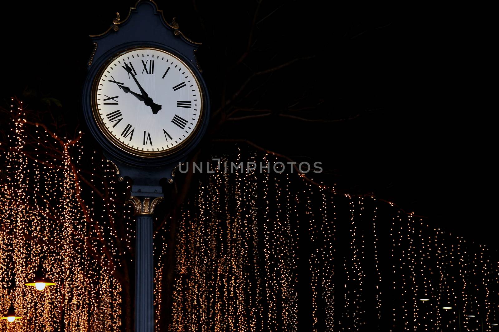 clock tower on street park night with bokeh lighting gold yellow background romantic nightlife