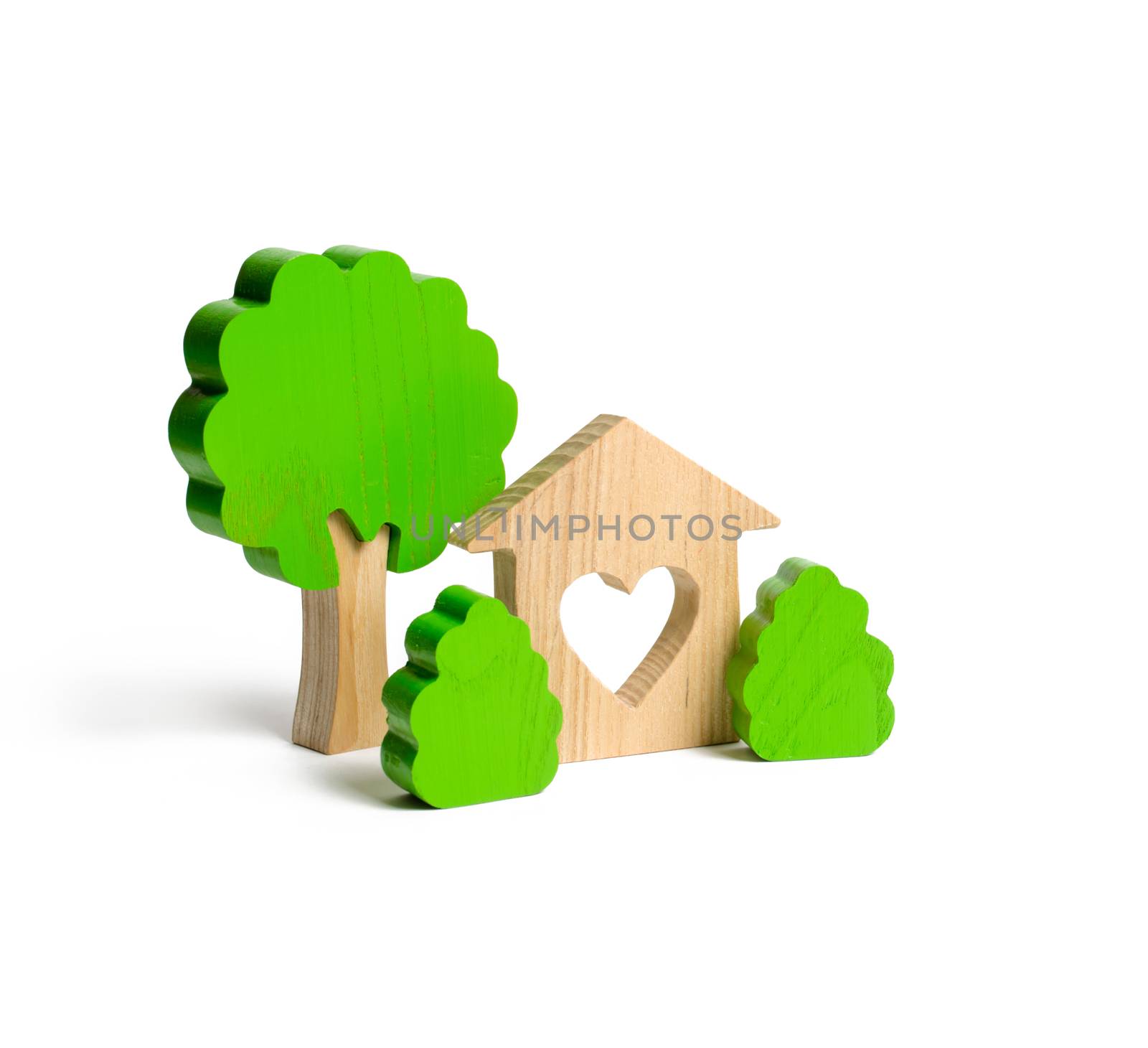 A house with a heart and wooden figures of trees with bushes on an isolated background. The concept of a love nest. Acquisition of affordable housing in a mortgage or loan. Accommodation for families.