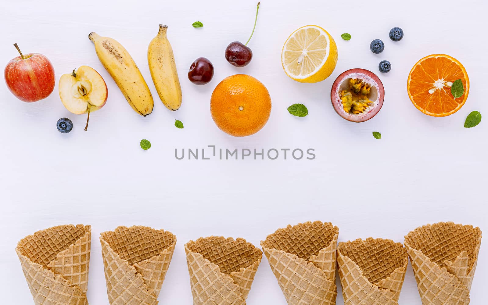 Flat lay various fresh fruits blueberry ,strawberry ,orange ,banana ,passion fruit ,apple and cherry setup on white background . Summer and Sweet menu concept.