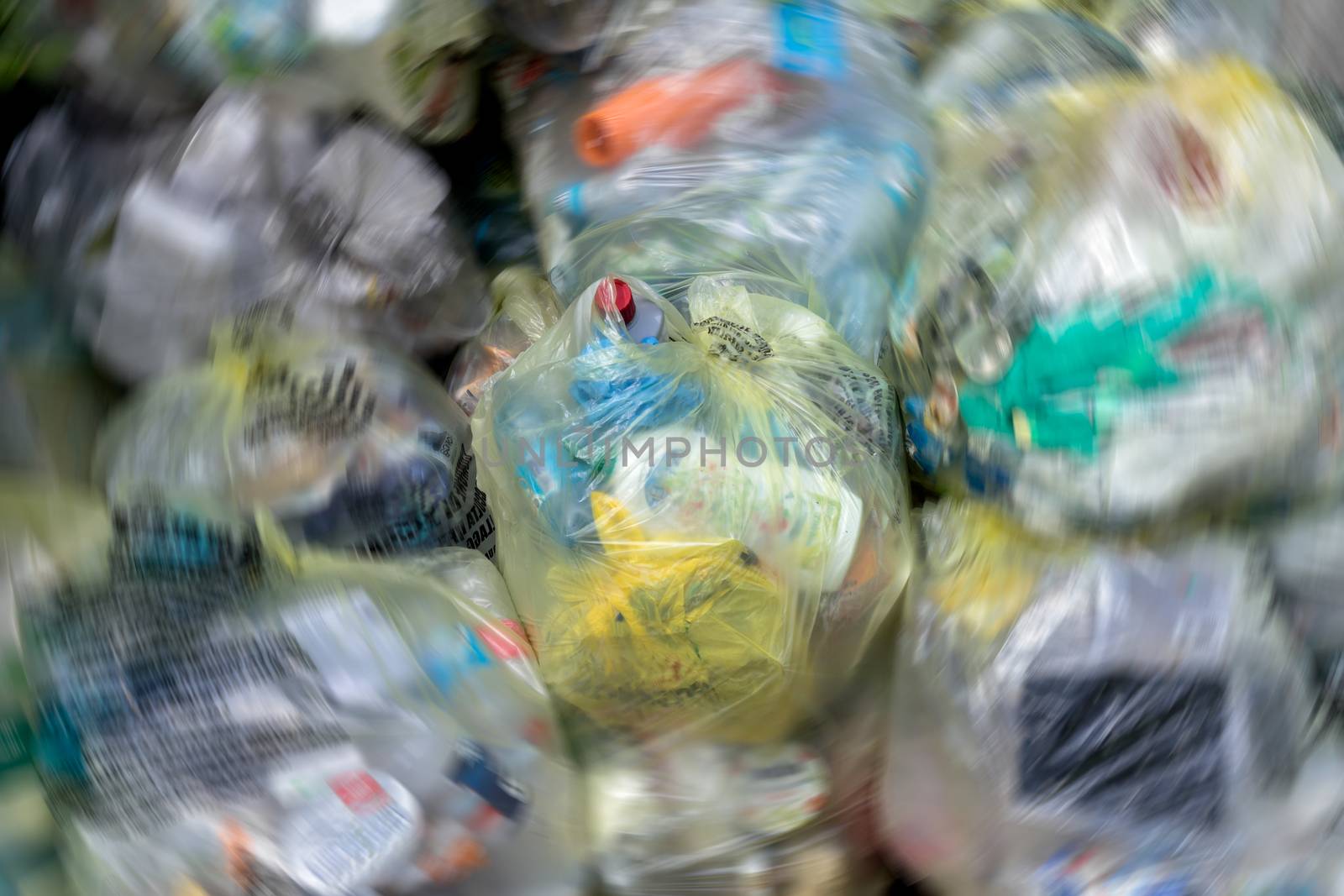 Close Up of garbage and waste in transparent bags. Radial blur effect.