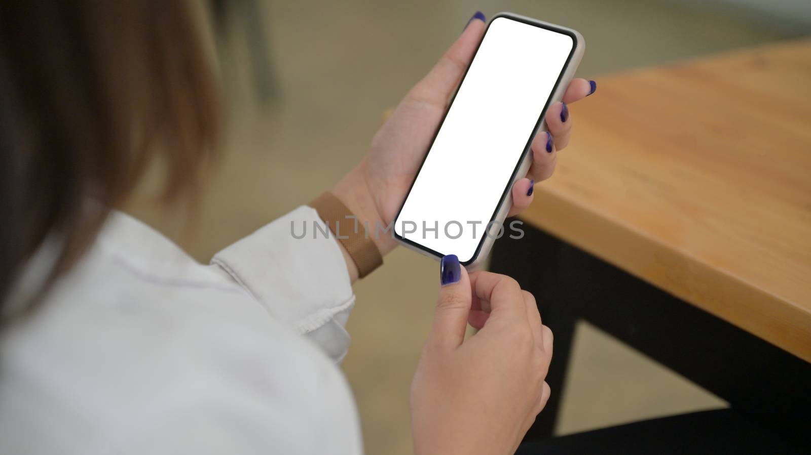 Cropped shot of Smartphone screen blank in young woman hand. by poungsaed