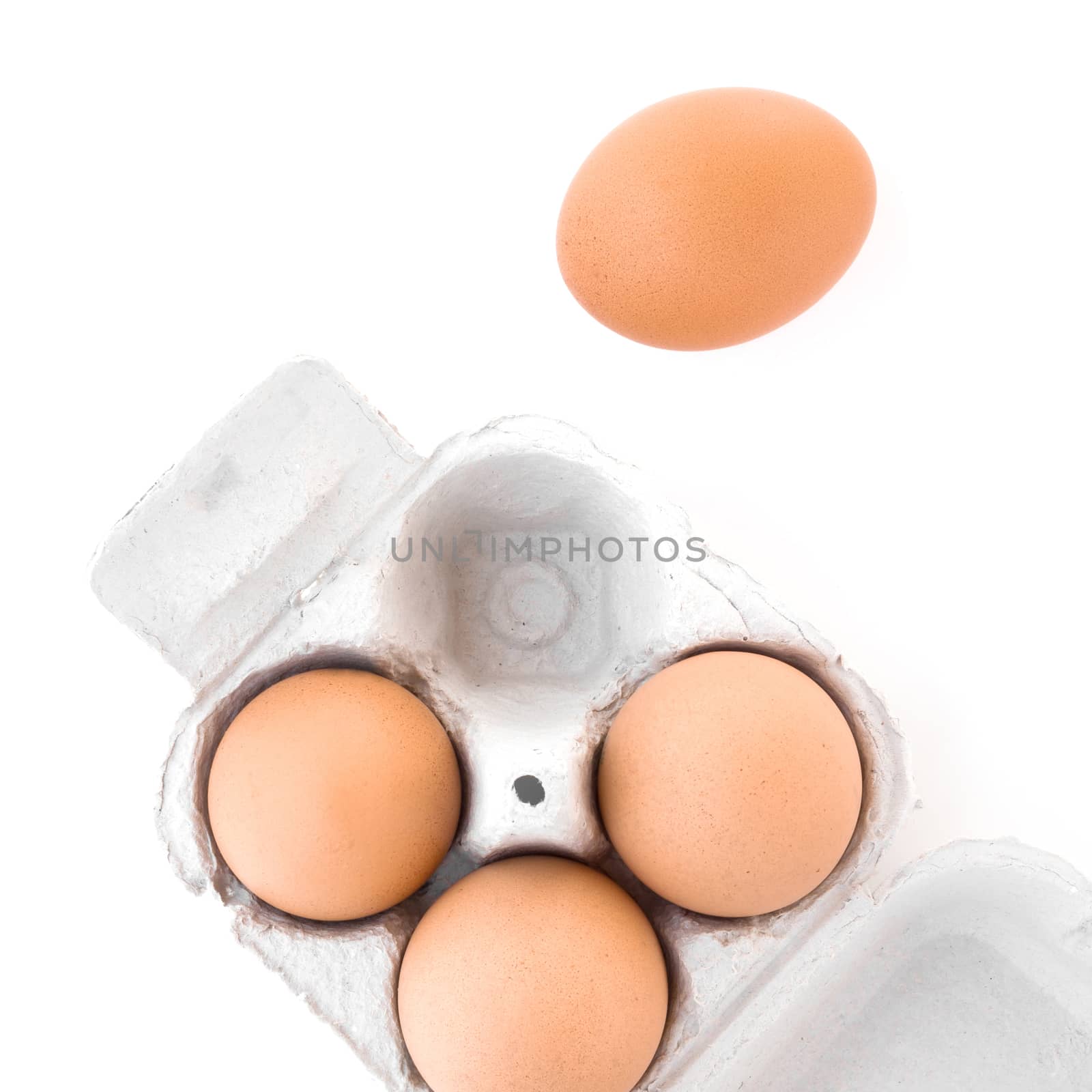 Top view fresh eggs in paper tray isolated on white background