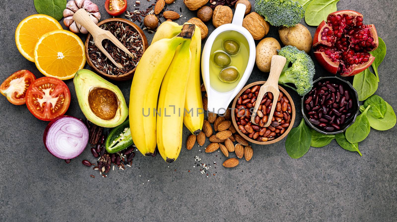 Ingredients for the healthy foods selection on dark background. Balanced healthy ingredients of unsaturated fats and fiber for the heart and blood vessels.