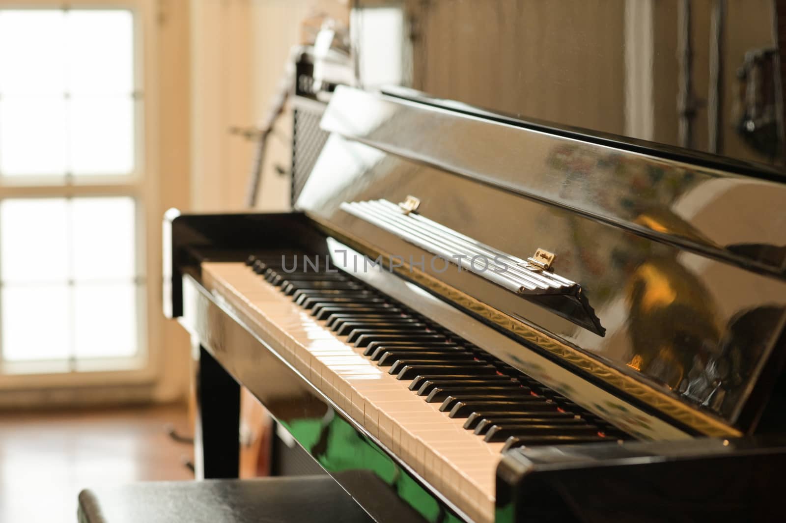 Cropped shot of Classical piano in a room with natural light thr by poungsaed