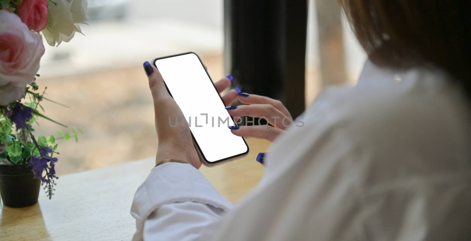 Hand of a young woman using a smartphone to search for informati by poungsaed
