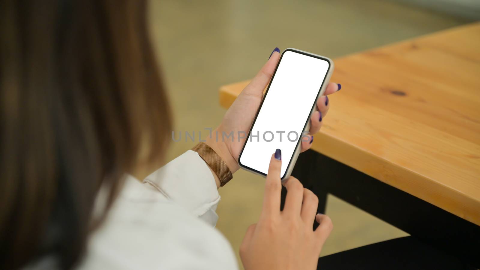 Close up shot of young woman holds and use the blank screen smartphone.