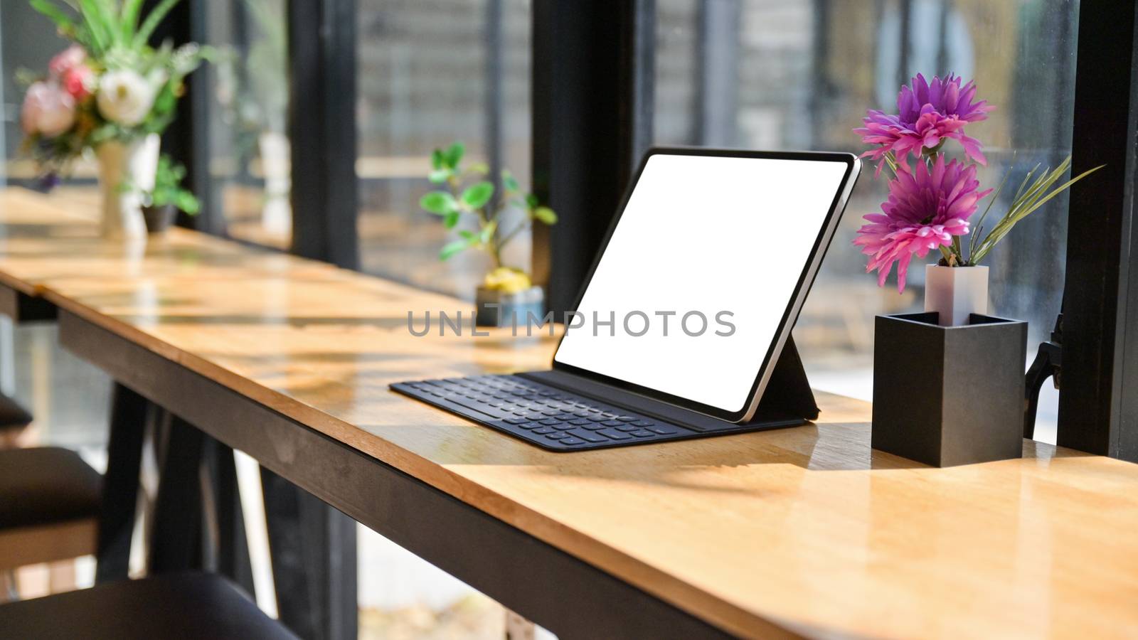 Cropped shot of Laptop with notebooks and stationary on a wooden by poungsaed