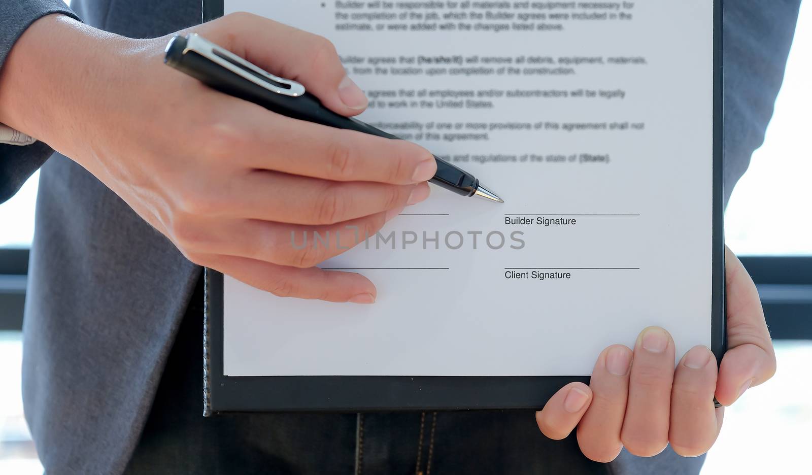 Cropped shot of The contractor pointed the pen at the builder to sign the contract to build the house.