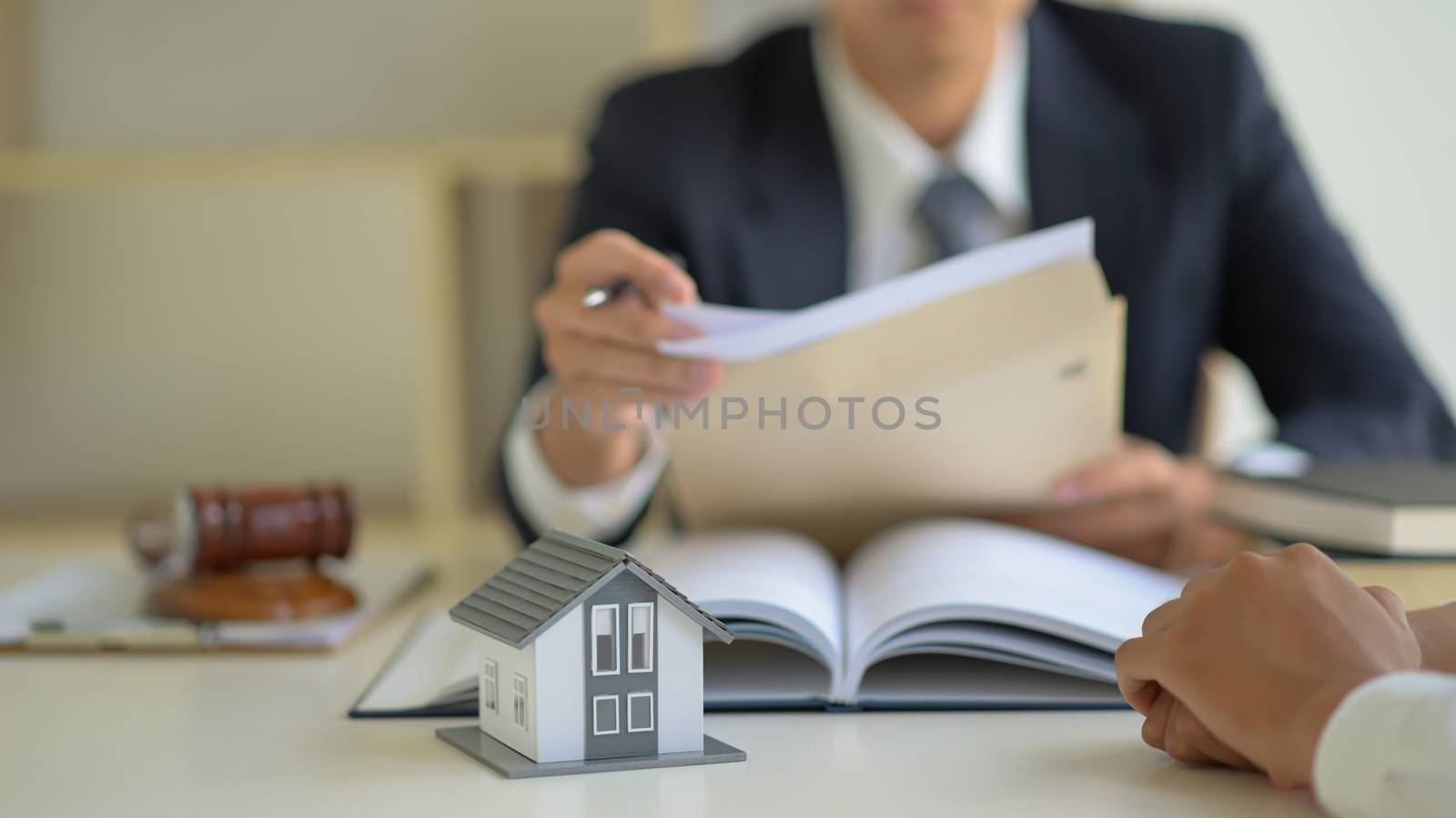 The lawyer is consulting clients about the house purchase contract.