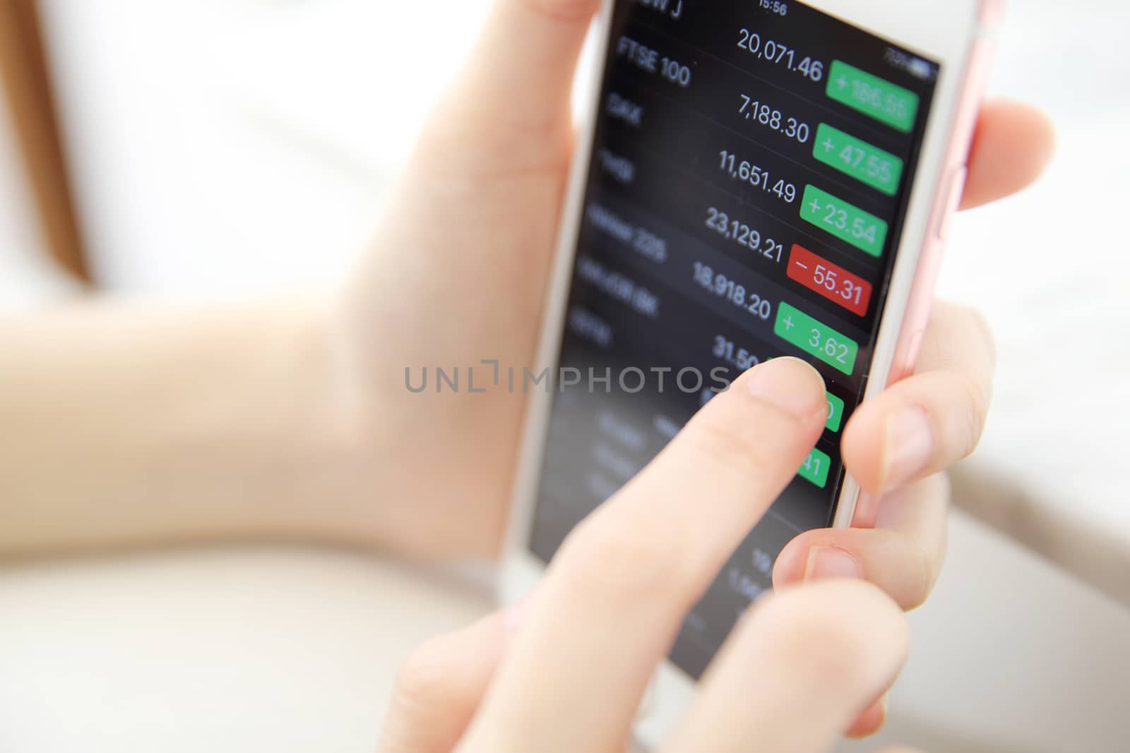 trading online on smartphone with bussiness woman hand