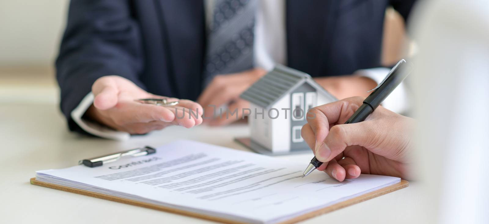 Signing a loan for a home purchase.