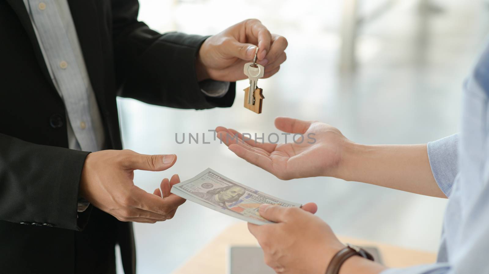 Customers and landlords exchange money and keys after agreeing t by poungsaed