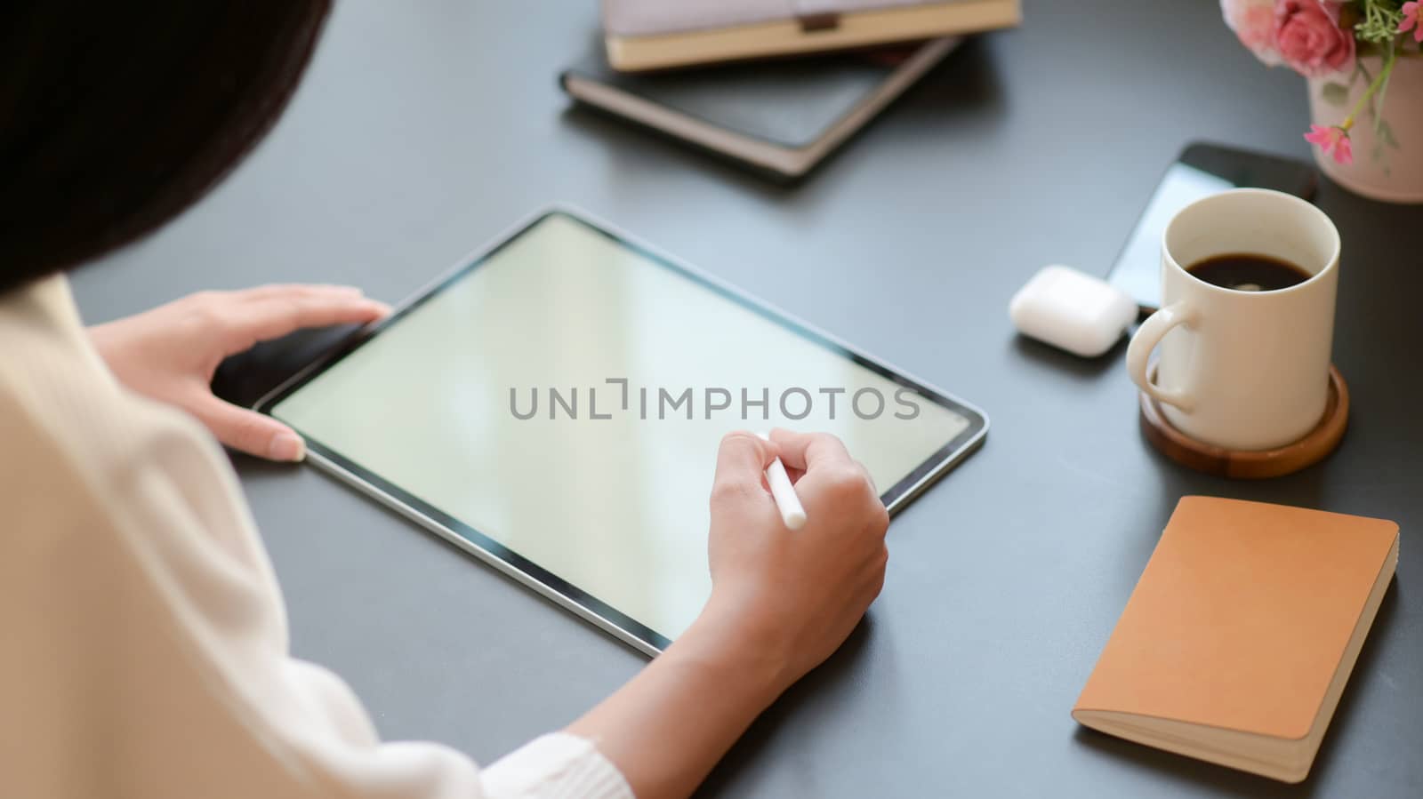 close - up view of a businesswoman is drafting an important program with a tablet for her important project.