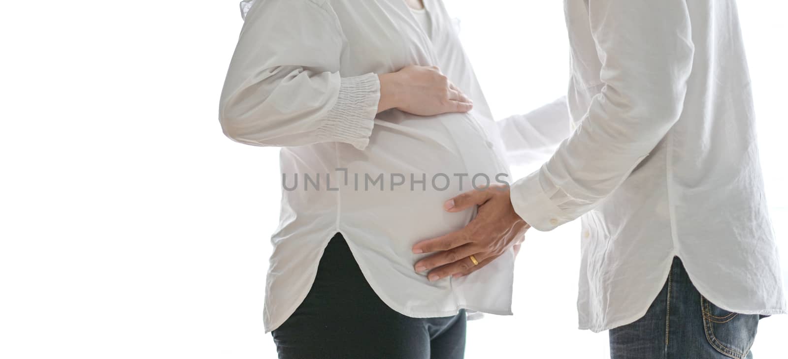 Men standing and embrace pregnant women.
