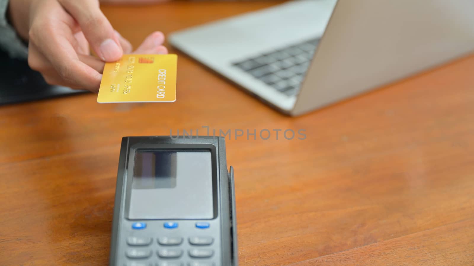 Close - up shot of Customers pay by credit card via EDC.