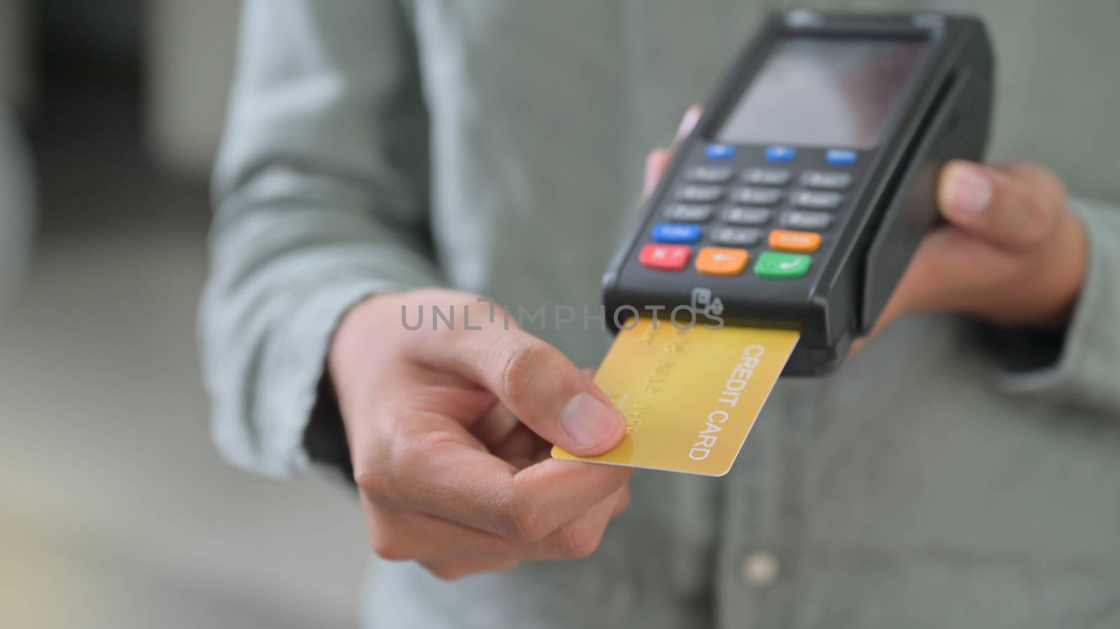 Close - up shot of Employees accept credit card payments via EDC.