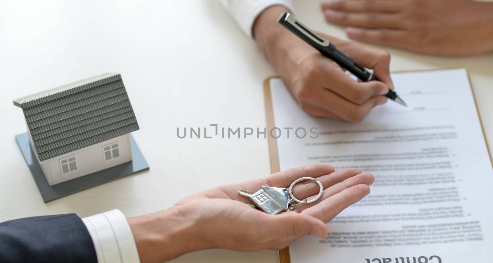 Signing a loan for a home purchase. by poungsaed
