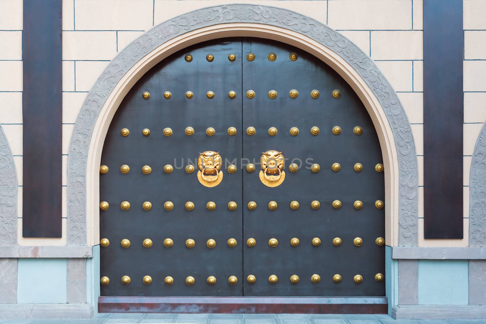 Chinese gate with golden colored door knockers, China