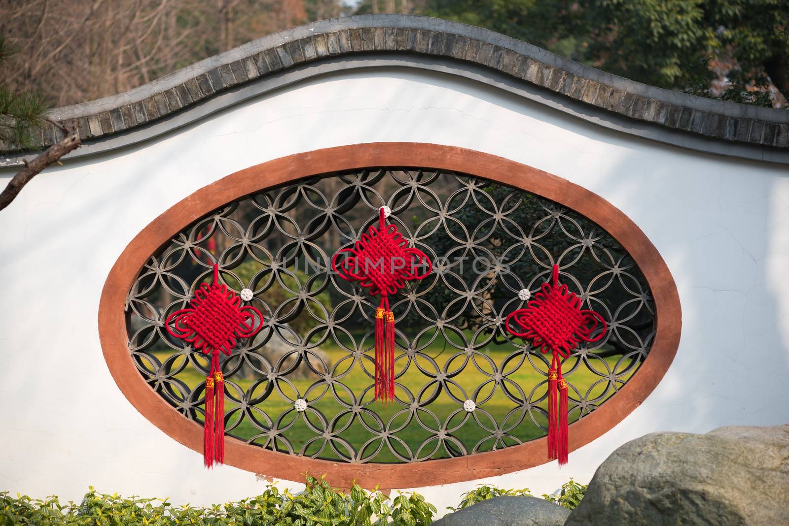 Red chinese lanterns decoration on a traditional window in Baihuatan public park Chengdu China for the Chinese new year celebrations.