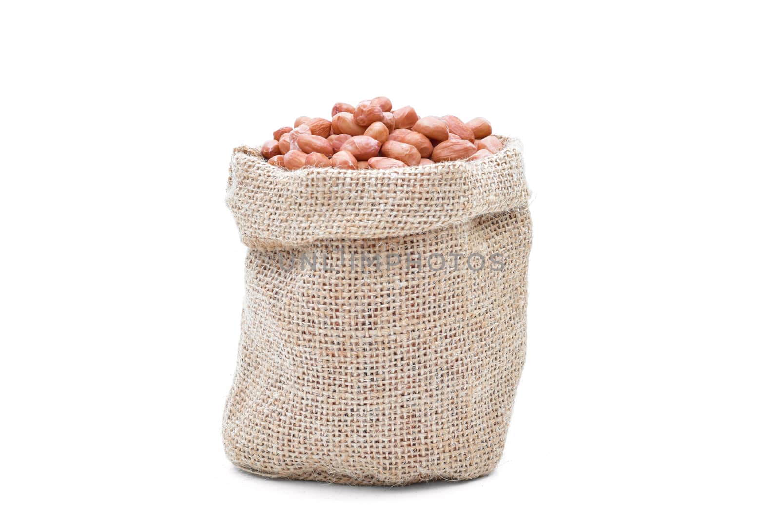 Peanuts raw grains in a sack of on white background