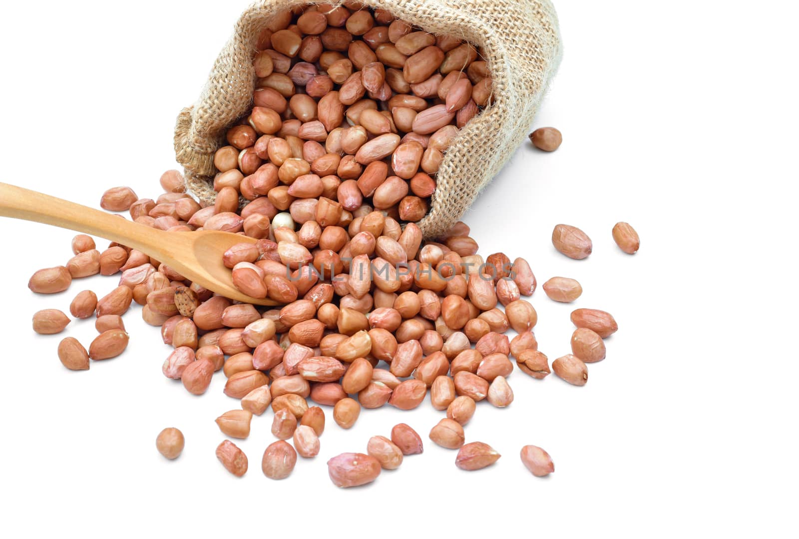 Peanuts raw grains in a sack of on white background