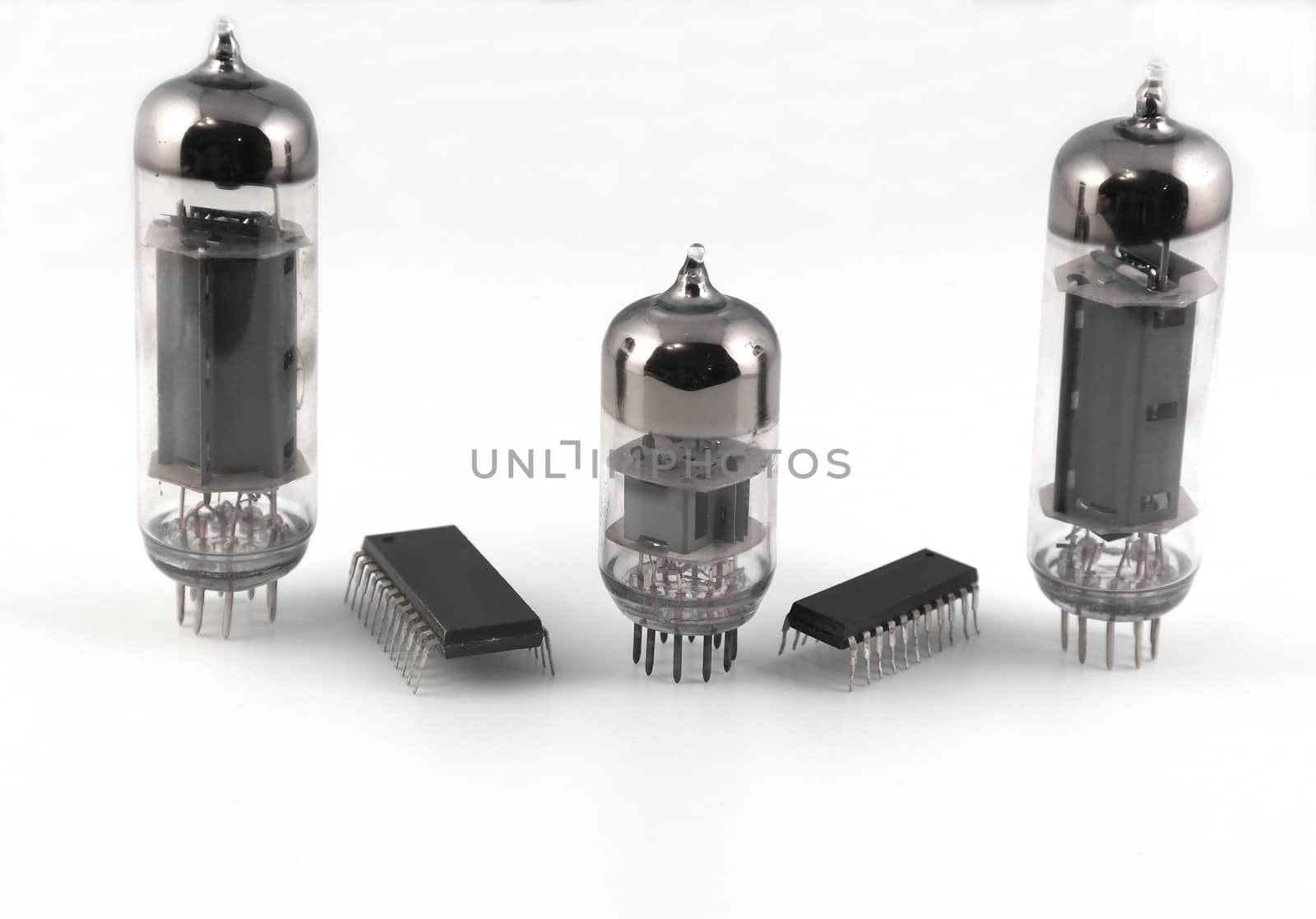 Vacuum radio tubes and microchips over white