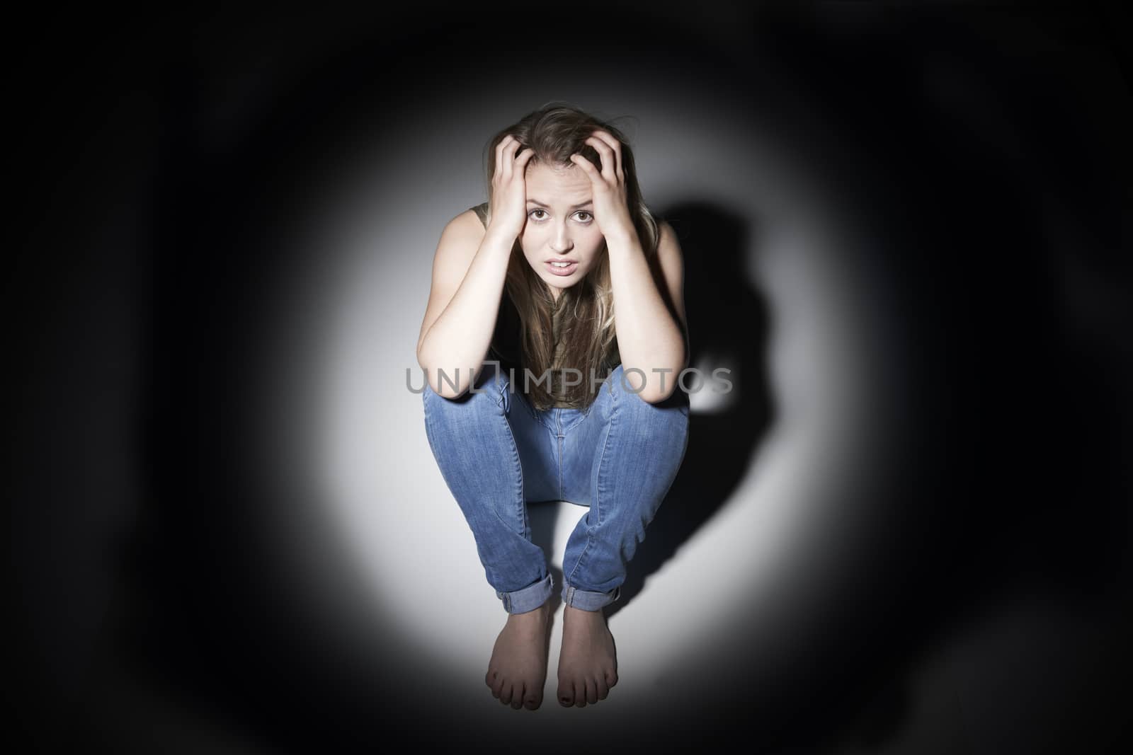 Unhappy Woman Sitting In Pool Of Light by HWS