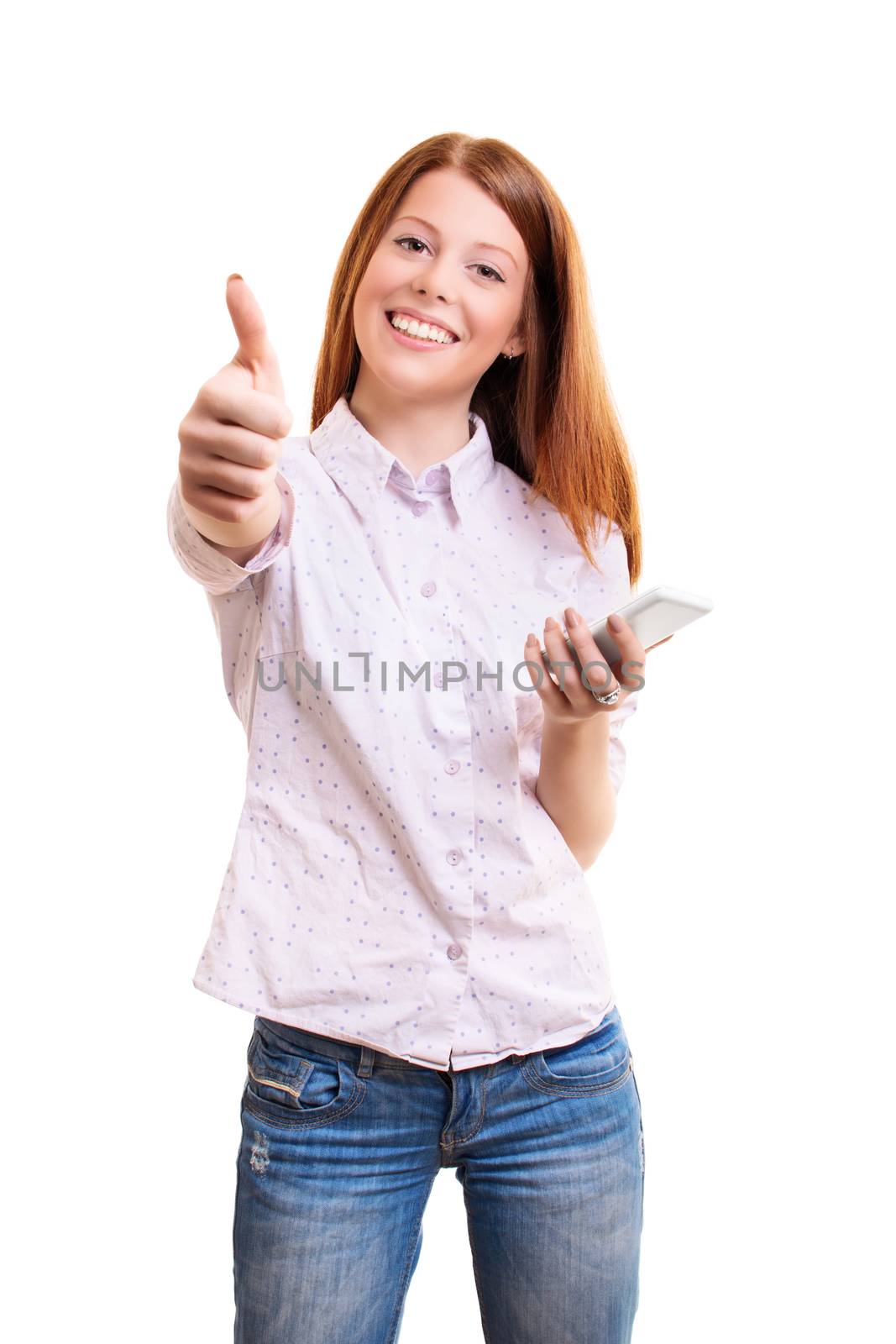 Portrait of a cheerful young girl in casual clothes holding mobile phone and giving thumb up, isolated on white background. Approval concept. Technology concept.